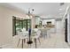 Eat-in kitchen featuring white cabinetry, granite countertops, stainless steel appliances, and a bay window at 7902 River Ridge Dr, Temple Terrace, FL 33637