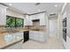 Well-appointed kitchen showcases granite countertops, white cabinets, and modern appliances at 7902 River Ridge Dr, Temple Terrace, FL 33637