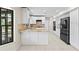 Bright kitchen boasts white cabinetry, granite countertops, and black stainless steel appliances at 7902 River Ridge Dr, Temple Terrace, FL 33637