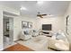 Bright living room with neutral decor, a ceiling fan, hardwood floors, and stylish contemporary furniture at 7902 River Ridge Dr, Temple Terrace, FL 33637