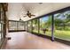 Relaxing screened patio with ceiling fans and serene views of the lush backyard at 7902 River Ridge Dr, Temple Terrace, FL 33637
