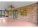 Screened porch with brick walls, ceiling fans, and views of the backyard at 7902 River Ridge Dr, Temple Terrace, FL 33637
