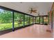 Spacious screened-in porch with ceiling fans, brick accents, and views of the lush yard at 7902 River Ridge Dr, Temple Terrace, FL 33637