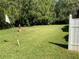 Expansive backyard featuring lush greenery, a water fountain, and a golf flag, offering a serene outdoor space at 819 Satinleaf Ave, Oldsmar, FL 34677