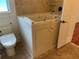 Accessible bathroom featuring a walk-in bathtub and modern toilet for convenient and safe bathing at 819 Satinleaf Ave, Oldsmar, FL 34677