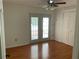 Bedroom with hardwood floors, ceiling fan, double doors to the outside, and a closet at 819 Satinleaf Ave, Oldsmar, FL 34677