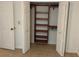 A walk-in closet with painted doors, installed shelfing, and carpeted floors for optimal clothing storage at 819 Satinleaf Ave, Oldsmar, FL 34677
