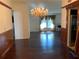 Elegant dining room featuring hardwood floors, decorative chandelier, and wainscoting, creating a stylish atmosphere at 819 Satinleaf Ave, Oldsmar, FL 34677