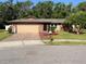 Charming single-story home featuring a brick facade, a well-manicured lawn, and a brick paved driveway at 819 Satinleaf Ave, Oldsmar, FL 34677