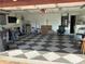 Spacious two car garage with a unique checkered floor, ample storage, and plenty of space for parking at 819 Satinleaf Ave, Oldsmar, FL 34677