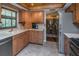 Traditional kitchen with wooden cabinets, stainless steel appliances, and views to the dining area at 819 Satinleaf Ave, Oldsmar, FL 34677