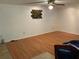 Open living room with hardwood floors, ceiling fan and unique art piece on the wall at 819 Satinleaf Ave, Oldsmar, FL 34677