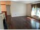 Inviting living room featuring hardwood floors, a decorative fireplace, and large windows offering natural light at 819 Satinleaf Ave, Oldsmar, FL 34677