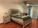 A well-lit main bedroom featuring a spacious layout, hardwood floors, and a ceiling fan at 819 Satinleaf Ave, Oldsmar, FL 34677
