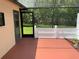 Covered outdoor patio area with a screened enclosure and a view of the greenery at 819 Satinleaf Ave, Oldsmar, FL 34677