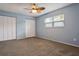 Bedroom with carpet, a ceiling fan, and two closets at 8350 Monarch Cir, Seminole, FL 33772