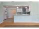 Kitchen and dining area with refinished cabinets, breakfast bar, and updated lighting at 8350 Monarch Cir, Seminole, FL 33772