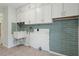 Functional laundry room featuring a utility sink and storage cabinets at 8350 Monarch Cir, Seminole, FL 33772