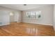 Bright living room with hardwood floors, shutters, and an arched entry to the front door at 8350 Monarch Cir, Seminole, FL 33772