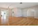 Open-concept living area with hardwood floors and seamless flow to the dining and kitchen areas at 8350 Monarch Cir, Seminole, FL 33772