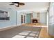 Bright living room features a brick fireplace, wood floors and ceiling fan at 8350 Monarch Cir, Seminole, FL 33772