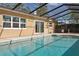 Enjoy the sunny pool with the Tiki Bar and convenient access to the home's interior at 8350 Monarch Cir, Seminole, FL 33772