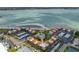 Aerial view of a beachfront complex featuring a pool, beach access, and well-maintained grounds at 865 S Gulfview Blvd # 306, Clearwater Beach, FL 33767