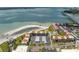Aerial view showcasing beachfront condos, parking, beach access, and scenic water views at 865 S Gulfview Blvd # 306, Clearwater Beach, FL 33767