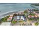 Aerial view showcases beachfront condos, pool, covered parking, and ocean views at 865 S Gulfview Blvd # 306, Clearwater Beach, FL 33767