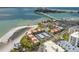 Stunning aerial view of waterfront condos with beautiful beach, pool, and covered parking at 865 S Gulfview Blvd # 306, Clearwater Beach, FL 33767