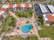 Wonderful aerial view of the large community pool surrounded by lush landscaping and lounge seating at 865 S Gulfview Blvd # 306, Clearwater Beach, FL 33767