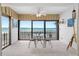 Inviting sunroom with a bistro set and panoramic water views at 865 S Gulfview Blvd # 306, Clearwater Beach, FL 33767