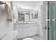Clean white bathroom with a vanity, mirror, and shower at 865 S Gulfview Blvd # 306, Clearwater Beach, FL 33767
