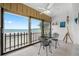 Dining area with ocean views, tile floors, and a ceiling fan at 865 S Gulfview Blvd # 306, Clearwater Beach, FL 33767