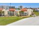 Condominium complex featuring multiple units with balconies, overlooking a well-manicured lawn at 865 S Gulfview Blvd # 306, Clearwater Beach, FL 33767