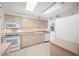 Bright kitchen with white appliances, light wood cabinets, and a window at 865 S Gulfview Blvd # 306, Clearwater Beach, FL 33767