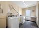 Bright laundry room featuring two machines, ample countertop space, and neutral-toned walls at 865 S Gulfview Blvd # 306, Clearwater Beach, FL 33767