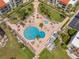 Aerial shot of the community pool and patio area with palm trees and seating at 865 S Gulfview Blvd # 306, Clearwater Beach, FL 33767