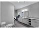This bathroom features a bathtub, a toilet, and a white vanity at 9019 S County Line Rd, Lithia, FL 33547