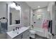 Well-lit bathroom featuring a flamingo-themed shower curtain, tub and a modern vanity at 9019 S County Line Rd, Lithia, FL 33547