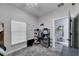 Well-lit bedroom with neutral walls, shelving for storage, and a window providing natural light at 9019 S County Line Rd, Lithia, FL 33547