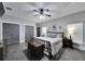 This bedroom features a ceiling fan, two windows, a bed, and a closet at 9019 S County Line Rd, Lithia, FL 33547