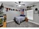 Neutral bedroom with a bed, and a TV set, decorated with rustic decor at 9019 S County Line Rd, Lithia, FL 33547
