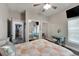 Bright bedroom showcasing a ceiling fan, quilt bedspread, and access to mirrored closets at 9019 S County Line Rd, Lithia, FL 33547