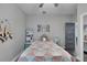 This quaint bedroom features gray walls, a decorative bedspread, and lots of storage at 9019 S County Line Rd, Lithia, FL 33547