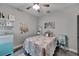 Adorable bedroom features a ceiling fan, a quilt bedspread, and gray flooring at 9019 S County Line Rd, Lithia, FL 33547