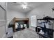 Comfortable bedroom featuring a wooden bunk bed, a ceiling fan, and bright natural lighting at 9019 S County Line Rd, Lithia, FL 33547