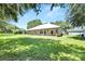 Well-maintained home exterior featuring a metal roof and a covered porch along the backside at 9019 S County Line Rd, Lithia, FL 33547