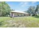 Exterior shot of the home showcasing its metal roof and covered porch at 9019 S County Line Rd, Lithia, FL 33547