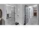 Hallway with grey doors leads to a bathroom and other rooms in the house at 9019 S County Line Rd, Lithia, FL 33547